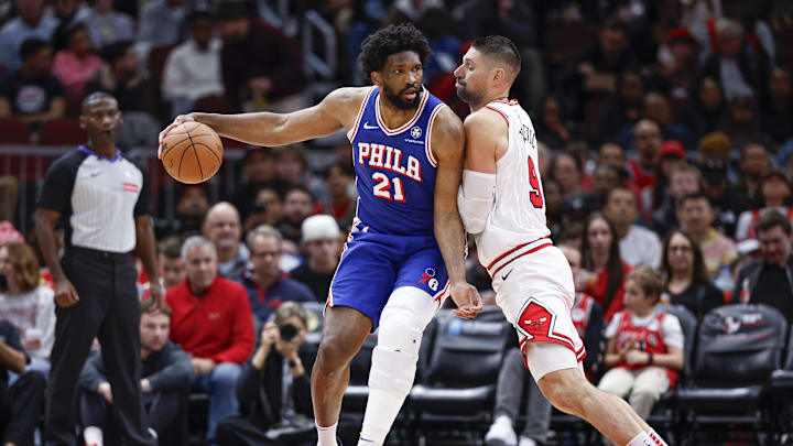 Dec 8, 2024; Chicago, Illinois, USA; Chicago Bulls center Nikola Vucevic (9) defends against Philadelphia 76ers center Joel Embiid (21) during the first half at United Center. Mandatory Credit: Kamil Krzaczynski-Imagn Images