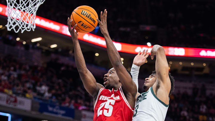 Mar 15, 2025; Indianapolis, IN, USA; Wisconsin Badgers guard John Blackwell (25) shoots the ball while Michigan State Spartans guard Jaden Akins (3) defends in the second half at Gainbridge Fieldhouse. 