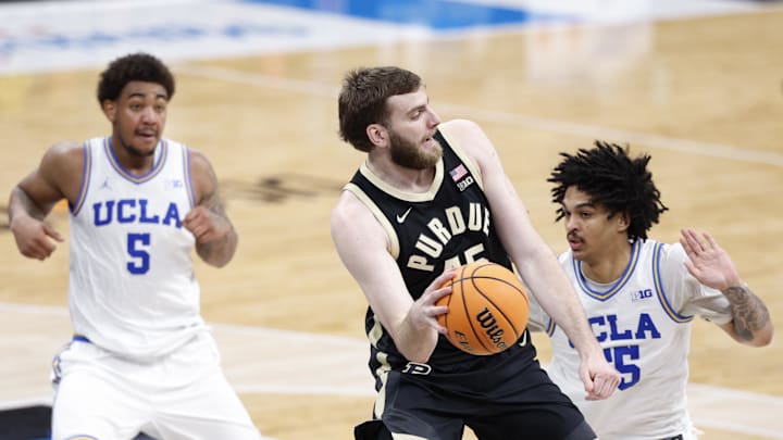 Mar 14, 2026; Chicago, IL, USA; Purdue Boilermakers center Oscar Cluff (45) tries to pass the ball against UCLA Bruins guard Skyy Clark (55) during the second half at United Center. Mandatory Credit: Kamil Krzaczynski-Imagn Images