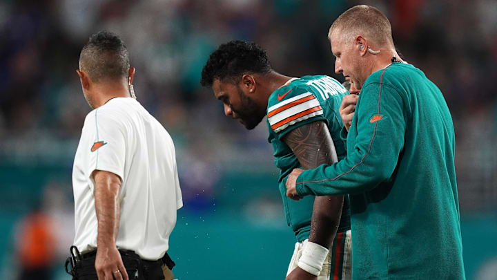 Sep 12, 2024; Miami Gardens, Florida, USA; Miami Dolphins quarterback Tua Tagovailoa (1) walks off the field with training staff after an apparent injury during the second half against the Buffalo Bills at Hard Rock Stadium. 