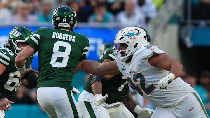 Miami Dolphins defensive tackle Zach Sieler (92) reaches for New York Jets quarterback Aaron Rodgers (8) during the second half at Hard Rock Stadium.