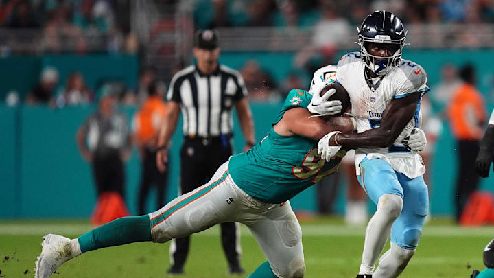Miami Dolphins defensive tackle Neil Farrell (97) tackles Tennessee Titans running back Tyjae Spears (2) during the first half at Hard Rock Stadium. Miami Dolphins defensive tackle Neil Farrell (97) tackles Tennessee Titans running back Tyjae Spears (2) during the first half at Hard Rock Stadium.