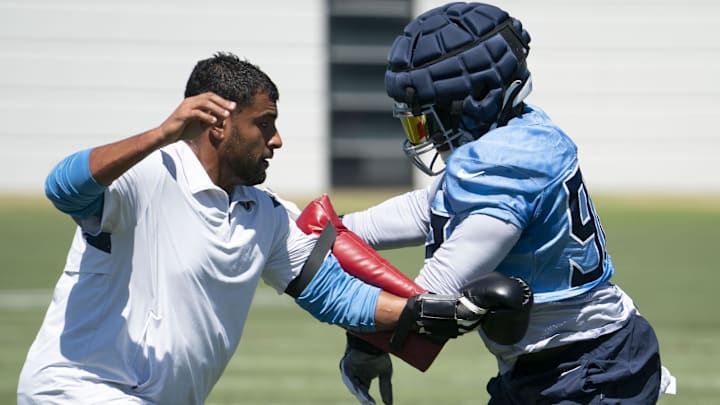 Tennessee Titans linebacker Ola Adeniyi (92) gets past outside linebackers coach Ryan Crow during practice at Ascension Saint Thomas Sports Park in 2022. Tennessee Titans linebacker Ola Adeniyi (92) gets past outside linebackers coach Ryan Crow during practice at Ascension Saint Thomas Sports Park in 2022.
