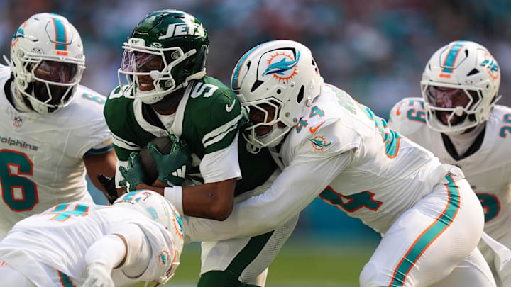 Miami Dolphins linebacker Chop Robinson (44) attempts to tackle New York Jets wide receiver Garrett Wilson (5) during the first half at Hard Rock Stadium.
