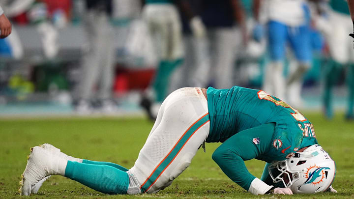 Sep 30, 2024; Miami Gardens, Florida, USA; Miami Dolphins linebacker Jaelan Phillips (15) reacts after an apparent injury during the second half against the Tennessee Titans at Hard Rock Stadium. 