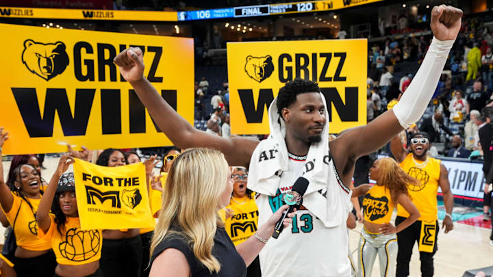 Grizzlies' Jaren Jackson Jr. (13) celebrates as he’s interviewed in front of a Grizzlies hype crew after the Grizzlies defeated the Mavericks 120-106 in the play-in game to secure a spot in the NBA Playoffs at FedExForum in Memphis, Tenn., on Friday, April 18, 2025.
