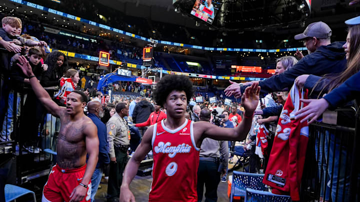 Grizzlies' Desmond Bane (22) and Jaylen Wells (0) high five fans after the Grizzlies defeated the Pelicans 139-126 at FedExForum on Friday, January 24, 2025, in Memphis, Tenn.