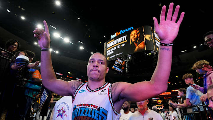 Grizzlies' Desmond Bane (22) high fives fans as he walks off the court after the Grizzlies defeated the Mavericks 120-106 in the play-in game to secure a spot in the NBA Playoffs at FedExForum in Memphis, Tenn., on Friday, April 18, 2025.