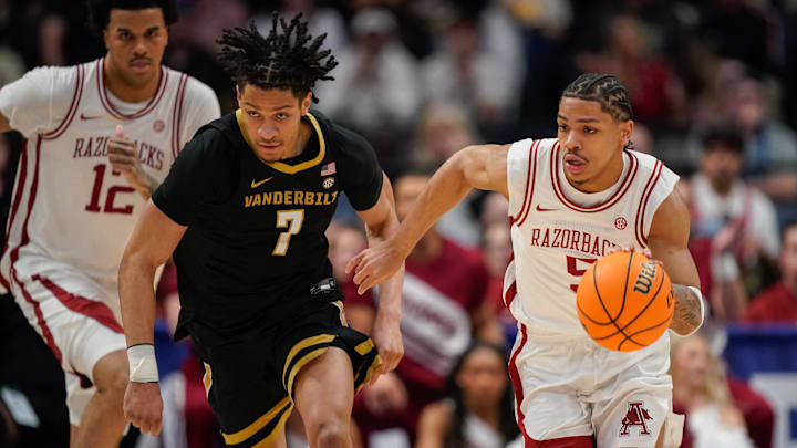 Arkansas guard Darius Acuff Jr. (5) drives around Vanderbilt guard Chandler Bing (7) during the first half of the SEC tournament championship game at Bridgestone Arena in Nashville, Tenn., Sunday, March 15, 2026.