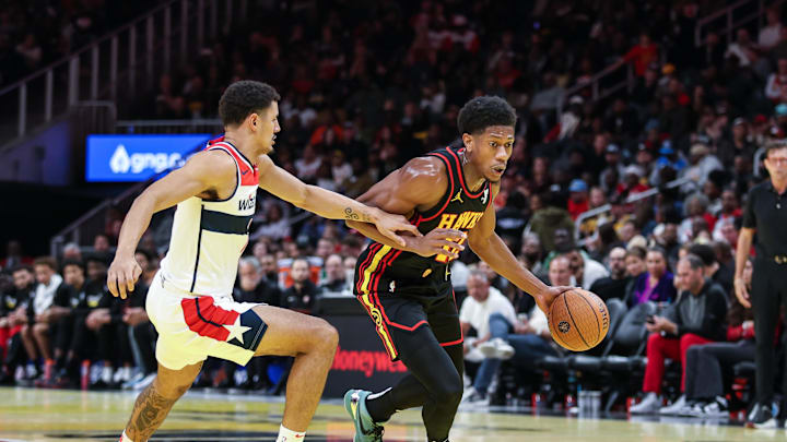 Nov 15, 2024; Atlanta, Georgia, USA; Atlanta Hawks forward De'Andre Hunter (12) dribbles the ball towards the goal against Washington Wizards guard Johnny Davis (1) during the third quarter at State Farm Arena. Mandatory Credit: Jordan Godfree-Imagn Images
