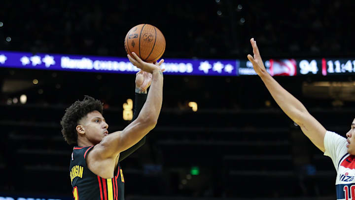 Nov 15, 2024; Atlanta, Georgia, USA; Atlanta Hawks forward Jalen Johnson (1) shoots the ball against Washington Wizards forward Kyshawn George (18) during the fourth quarter at State Farm Arena. Mandatory Credit: Jordan Godfree-Imagn Images
