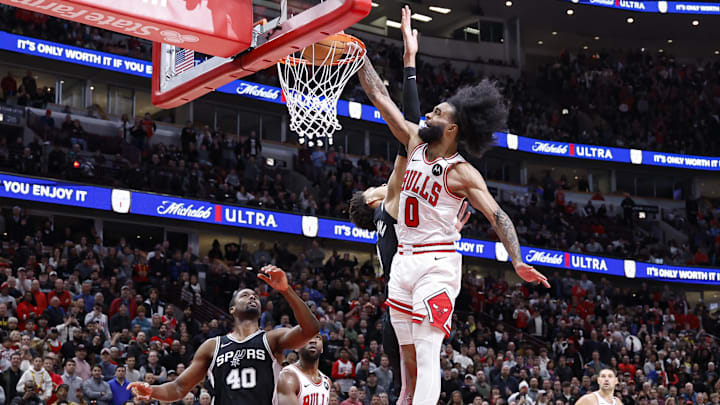 Jan 6, 2025; Chicago, Illinois, USA; Chicago Bulls guard Coby White (0) shoots against San Antonio Spurs center Victor Wembanyama (1) during the second half at United Center. Mandatory Credit: Kamil Krzaczynski-Imagn Images