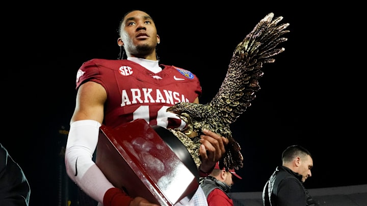 Arkansas’ Taylen Green (10) holds up his MVP trophy after Arkansas defeated Texas Tech 36-26 in the AutoZone Liberty Bowl in Memphis, Tenn., on Friday, December 27, 2024.