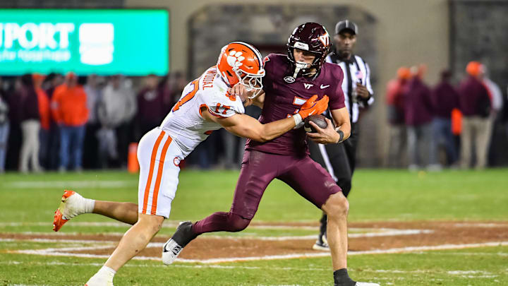 Nov 9, 2024; Blacksburg, Virginia, USA; Clemson Tigers linebacker Wade Woodaz (17) tackles Virginia Tech Hokies quarterback Collin Schlee (3) during the fourth quarter at Lane Stadium. Mandatory Credit: Brian Bishop-Imagn Images Nov 9, 2024; Blacksburg, Virginia, USA; Clemson Tigers linebacker Wade Woodaz (17) tackles Virginia Tech Hokies quarterback Collin Schlee (3) during the fourth quarter at Lane Stadium. Mandatory Credit: Brian Bishop-Imagn Images