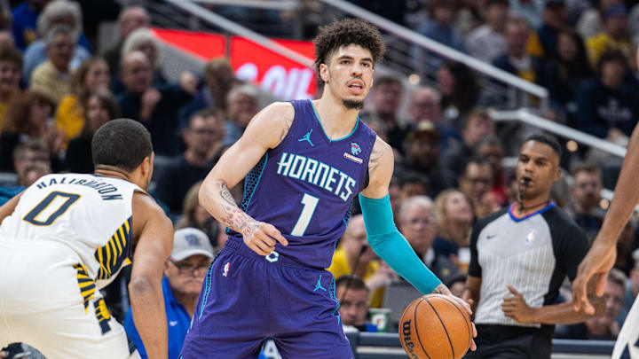 Nov 4, 2023; Indianapolis, Indiana, USA; Charlotte Hornets guard LaMelo Ball (1) dribbles the ball while Indiana Pacers guard Tyrese Haliburton (0) defends in the first quarter at Gainbridge Fieldhouse. Mandatory Credit: Trevor Ruszkowski-Imagn Images