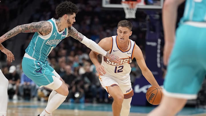 Phoenix Suns guard Collin Gillespie (12) brings the ball up court against Charlotte Hornets guard LaMelo Ball 
