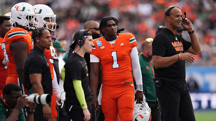 Dec 28, 2024; Orlando, FL, USA; Miami Hurricanes quarterback Cam Ward (1) stands on the sideline during the first half against the Iowa State Cyclones at Camping World Stadium. Mandatory Credit: Jasen Vinlove-Imagn Images