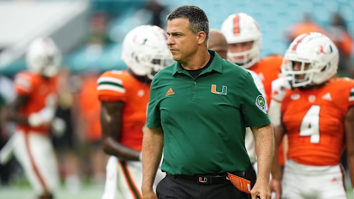 Sep 24, 2022; Miami Gardens, Florida, USA; Miami Hurricanes head coach Mario Cristobal stands on the field  prior to the game against the Middle Tennessee Blue Raiders at Hard Rock Stadium. Mandatory Credit: Jasen Vinlove-Imagn Images
