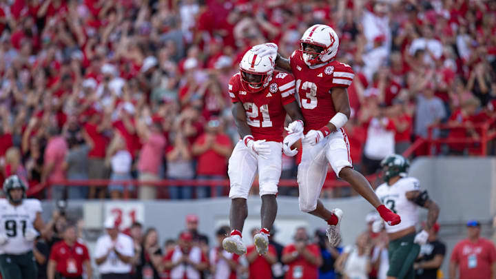 Oct 4, 2025; Lincoln, Nebraska, USA; Nebraska Cornhuskers running back Emmett Johnson (21) and wide receiver Nyziah Hunter (13) celebrate after a touchdown