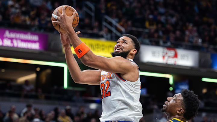 Feb 11, 2025; Indianapolis, Indiana, USA; New York Knicks center Karl-Anthony Towns (32) shoots the ball while Indiana Pacers center Thomas Bryant (3) defends in the second half at Gainbridge Fieldhouse. Mandatory Credit: Trevor Ruszkowski-Imagn Images