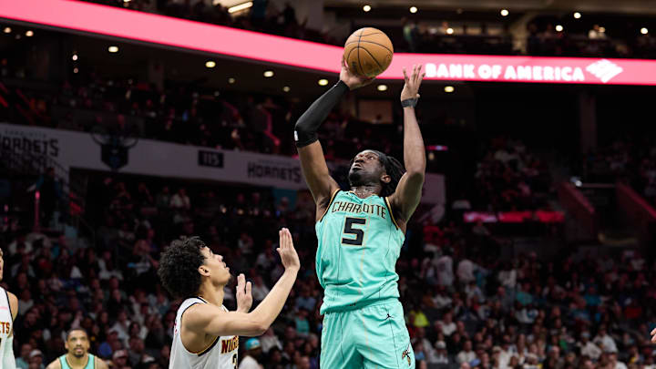Feb 1, 2025; Charlotte, North Carolina, USA; Charlotte Hornets center Mark Williams (5) shoots over Denver Nuggets guard Julian Strawther (3) during the second half of play at Spectrum Center. Mandatory Credit: Brian Westerholt-Imagn Images