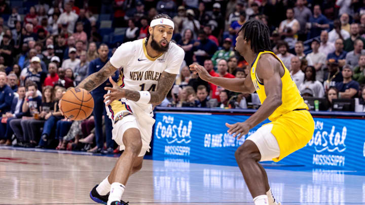 Nov 1, 2024; New Orleans, Louisiana, USA;  New Orleans Pelicans forward Brandon Ingram (14) dribbles against Indiana Pacers forward Aaron Nesmith (23) during the first half at Smoothie King Center. Mandatory Credit: Stephen Lew-Imagn Images
