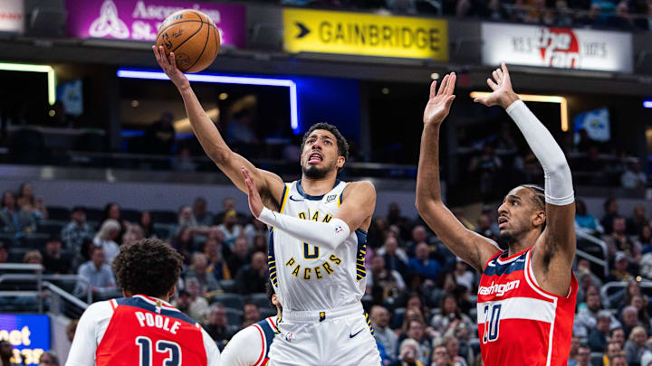 Apr 8, 2025; Indianapolis, Indiana, USA; Indiana Pacers guard Tyrese Haliburton (0) shoots the ball while Washington Wizards forward Alex Sarr (20) defends in the first half at Gainbridge Fieldhouse. Mandatory Credit: Trevor Ruszkowski-Imagn Images