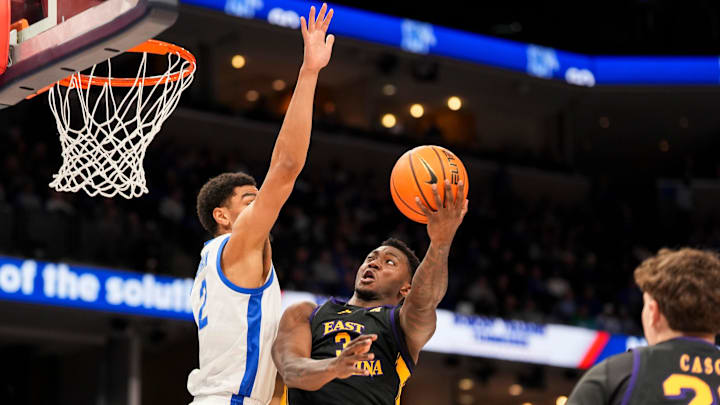 Memphis' Nicholas Jourdain (2) tries to block East Carolina's RJ Felton (3) as he goes for a layup during the game between East Carolina University and University of Memphis at FedExForum in Memphis, Tenn., on Saturday, January 11, 2025. Memphis' Nicholas Jourdain (2) tries to block East Carolina's RJ Felton (3) as he goes for a layup during the game between East Carolina University and University of Memphis at FedExForum in Memphis, Tenn., on Saturday, January 11, 2025.