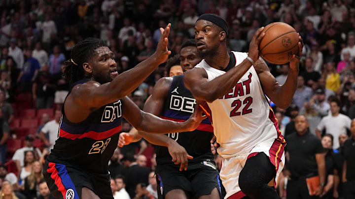 Oct 25, 2023; Miami, Florida, USA; Miami Heat forward Jimmy Butler (22) passes the ball away from Detroit Pistons center Isaiah Stewart (28) during the first second half at Kaseya Center. Mandatory Credit: Jasen Vinlove-USA TODAY Sports