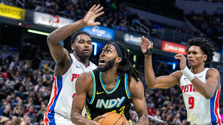 Nov 24, 2023; Indianapolis, Indiana, USA; Indiana Pacers forward Isaiah Jackson (22) shoots the ball while Detroit Pistons center Isaiah Stewart (28) and forward Ausar Thompson (9) defend in the second half at Gainbridge Fieldhouse. Mandatory Credit: Trevor Ruszkowski-Imagn Images