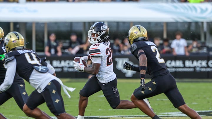 Nov 22, 2025; Orlando, Florida, USA; Oklahoma State Cowboys running back Rodney Fields Jr. (20) runs the ball during the first quarter against the UCF Knights at Acrisure Bounce House. Mandatory Credit: Mike Watters-Imagn Images