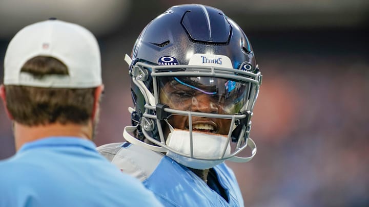 Tennessee Titans quarterback Cam Ward (1) talks to coach Brian Callahan during the first quarter of an NFL pre-season game against the Minnesota Vikings at Nissan Stadium in Nashville, Tenn., Friday, Aug. 22, 2025.