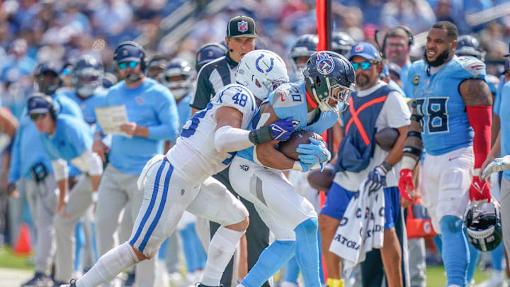 Tennessee Titans running back Tony Pollard is pushed out of bounds by Indianapolis Colts linebacker Joe Bachie. Tennessee Titans running back Tony Pollard is pushed out of bounds by Indianapolis Colts linebacker Joe Bachie.