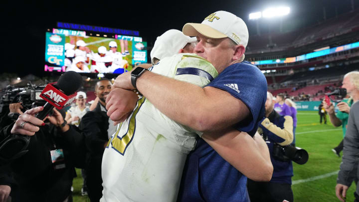 Dec 22, 2023; Tampa, FL, USA; Georgia Tech Yellow Jackets quarterback Haynes King (10) hugs head coach Brent Key after defeating UCF Knights in the Gasparilla Bowl at Raymond James Stadium. Mandatory Credit: Jasen Vinlove-USA TODAY Sports