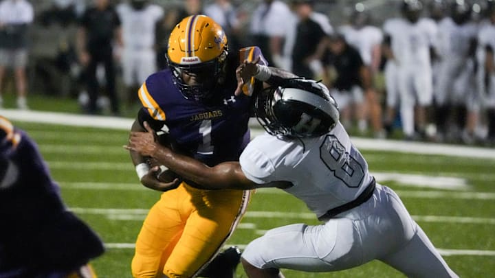 DeSoto Central’s Eric Perry (1) stiff arms Houston’s Ben Killebrew (8) as he runs with the ball during the game between Houston High School and DeSoto Central High School in Southaven, Miss., on Thursday, August 29, 2024. DeSoto Central’s Eric Perry (1) stiff arms Houston’s Ben Killebrew (8) as he runs with the ball during the game between Houston High School and DeSoto Central High School in Southaven, Miss., on Thursday, August 29, 2024.