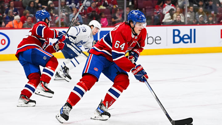 Sep 30, 2023; Montreal, Quebec, CAN; Montreal Canadiens defenseman David Reinbacher (64) plays the puck against the Toronto Maple Leafs during the third period at Bell Centre. Mandatory Credit: David Kirouac-Imagn Images
