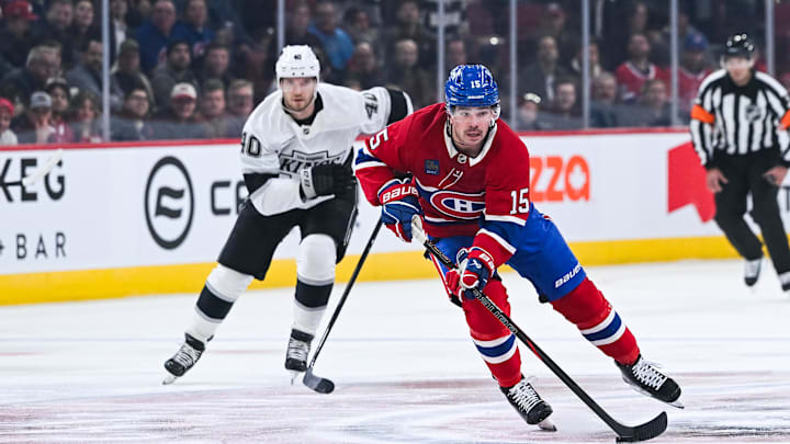Nov 11, 2025; Montreal, Quebec, CAN; Montreal Canadiens center Alex Newhook (15) plays the puck against Los Angeles Kings right wing Joel Armia (40) during the first period at Bell Centre. Mandatory Credit: David Kirouac-Imagn Images