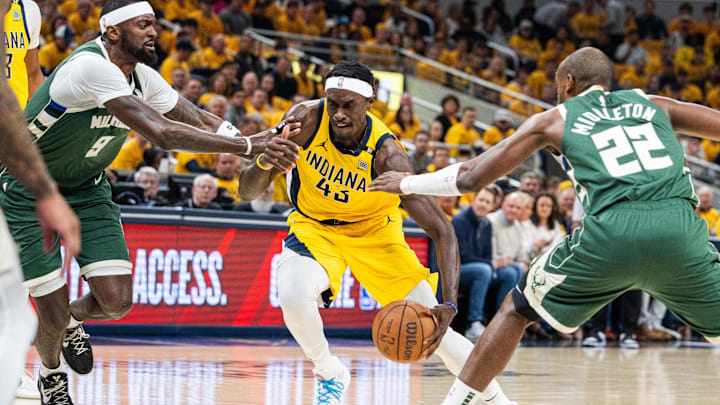 Apr 26, 2024; Indianapolis, Indiana, USA; Indiana Pacers forward Pascal Siakam (43) dribbles the ball while Milwaukee Bucks forward Bobby Portis (9) and forward Khris Middleton (22)  defend during game three of the first round for the 2024 NBA playoffs at Gainbridge Fieldhouse. Mandatory Credit: Trevor Ruszkowski-Imagn Images