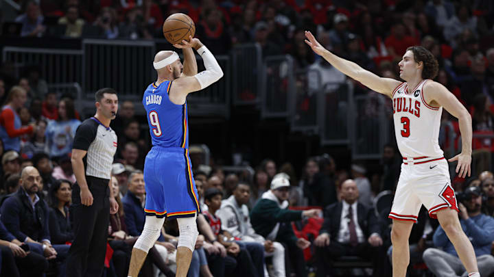 Oct 26, 2024; Chicago, Illinois, USA; Oklahoma City Thunder guard Alex Caruso (9) shoots against Chicago Bulls guard Josh Giddey (3) during the first half at United Center. Mandatory Credit: Kamil Krzaczynski-Imagn Images