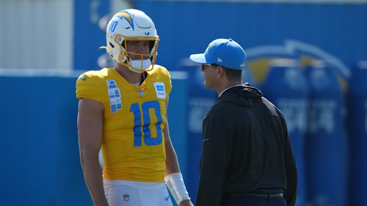 Aug 7, 2025; El Segundo, CA, USA; Los Angeles Chargers quarterback Justin Herbert (10) talks with coach Jim Harbaugh during training camp at The Bolt. Mandatory Credit: Kirby Lee-Imagn Images