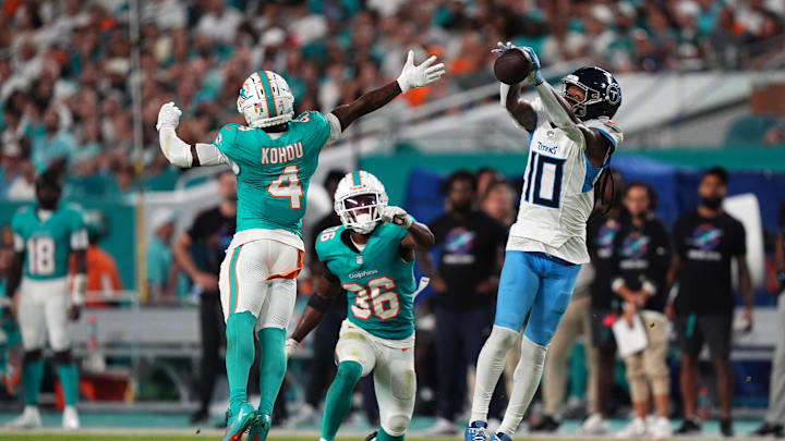 Sep 30, 2024; Miami Gardens, Florida, USA; Tennessee Titans wide receiver DeAndre Hopkins (10) attempts to make a catch behind Miami Dolphins cornerback Kader Kohou (4) during the first half at Hard Rock Stadium. Mandatory Credit: Jasen Vinlove-Imagn Images