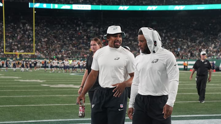 East Rutherford, NJ -- August 22, 2025 -- Jalen Hurts and Saquon Barkley of the Eagles walk off of the field at the end of the first half. The Philadelphia Eagles came to MetLife Stadium to play the NY Jets in the final preseason season game.