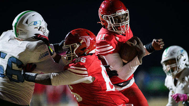 Seventy-First’s Ziare Ealy blocks J.H. Rose’s Martis Bradley as Seventy-First’s Deandre Nance slides by for a touchdown during the third quarter on Friday, Dec. 6, 2024, at Seventy-First High School.