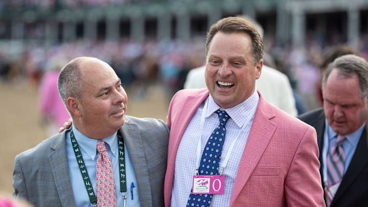 Trainer Tom Amoss, right is congratulated by Steve Hargrave, Director of Backside Operations for Churchill Downs, after Amoss' horse, Serengeti Empress wins the Kentucky Oaks. May 3, 2019.