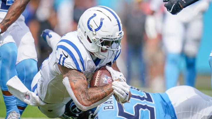 Sep 21, 2025; Nashville, Tennessee, USA; Indianapolis Colts wide receiver Michael Pittman (11) dives past Tennessee Titans linebacker Cody Barton (50) for a touchdown during the third quarter at Nissan Stadium. Mandatory Credit: Andrew Nelles-USA TODAY Network via Imagn Images