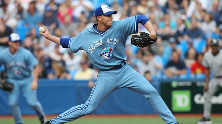Toronto Blue Jays pitcher Roy Halladay throws a pitch wearing a powder blue jersey and white and blue hat. Toronto Blue Jays pitcher Roy Halladay throws a pitch wearing a powder blue jersey and white and blue hat.