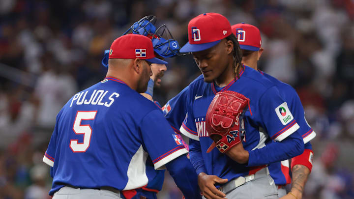 Mar 11, 2026; Miami, FL, United States; Dominican Republic pitcher Abner Uribe (45) is taken out of the game by manager Albert Pujols (5) during the ninth inning against Venezuela at loanDepot Park. Mandatory Credit: Sam Navarro-Imagn Images