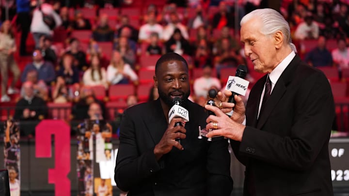 Jan 14, 2024; Miami, Florida, USA; Miami Heat president Pat Riley (R) shows former player Dwayne Wade (L) a bobble head while announcing that a statue in the likeness of Wade will be erected outside the arena in 2025, during halftime of the game between the Miami Heat and the Charlotte Hornets at Kaseya Center. Mandatory Credit: Jasen Vinlove-Imagn Images Jan 14, 2024; Miami, Florida, USA; Miami Heat president Pat Riley (R) shows former player Dwayne Wade (L) a bobble head while announcing that a statue in the likeness of Wade will be erected outside the arena in 2025, during halftime of the game between the Miami Heat and the Charlotte Hornets at Kaseya Center. Mandatory Credit: Jasen Vinlove-Imagn Images