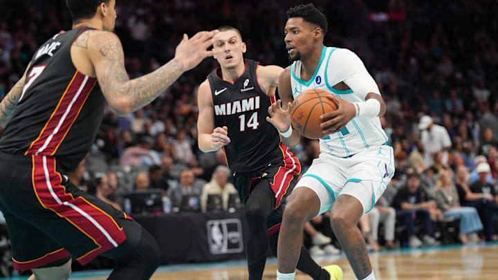 Apr 14, 2026; Charlotte, North Carolina, USA; Charlotte Hornets forward Brandon Miller (24) handles the ball guarded by Miami Heat guard Tyler Herro (14) and center Kel'el Ware (7) during the second half during the play-in rounds between the Charlotte Hornets and the Miami Heat of the 2026 NBA Playoffs at Spectrum Center. Mandatory Credit: Jim Dedmon-Imagn Images
