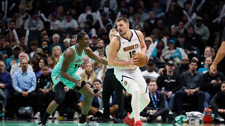 Feb 1, 2025; Charlotte, North Carolina, USA; Denver Nuggets center Nikola Jokic (15) is defended by Charlotte Hornets forward Moussa Diabate (14) during the second half of play at Spectrum Center. Mandatory Credit: Brian Westerholt-Imagn Images